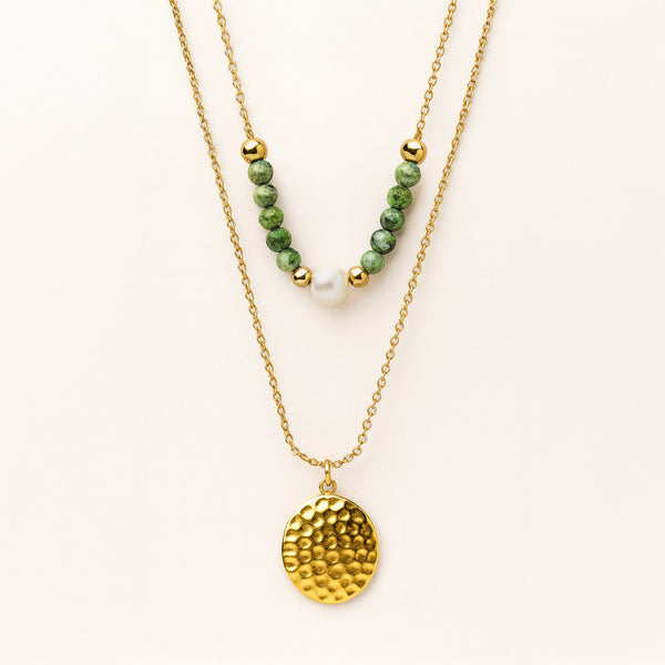Two gold necklaces on a white background